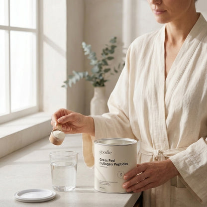Woman adding Goodie collagen peptides to her water